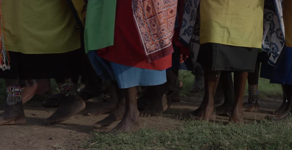 Maasai walk barefoot across the ground