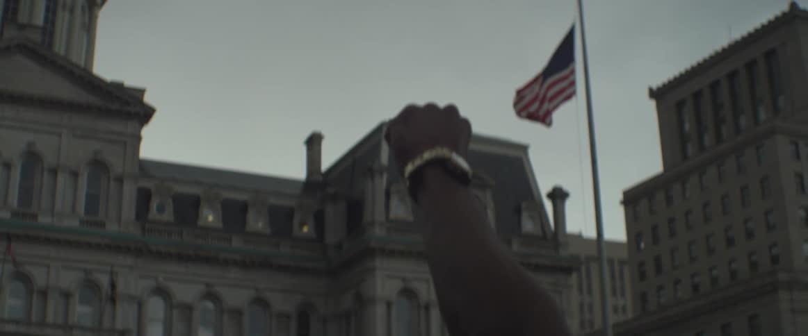 A man raises his fist to the sky
