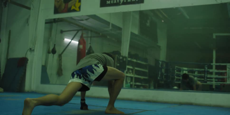 A man is exercising on gym mats