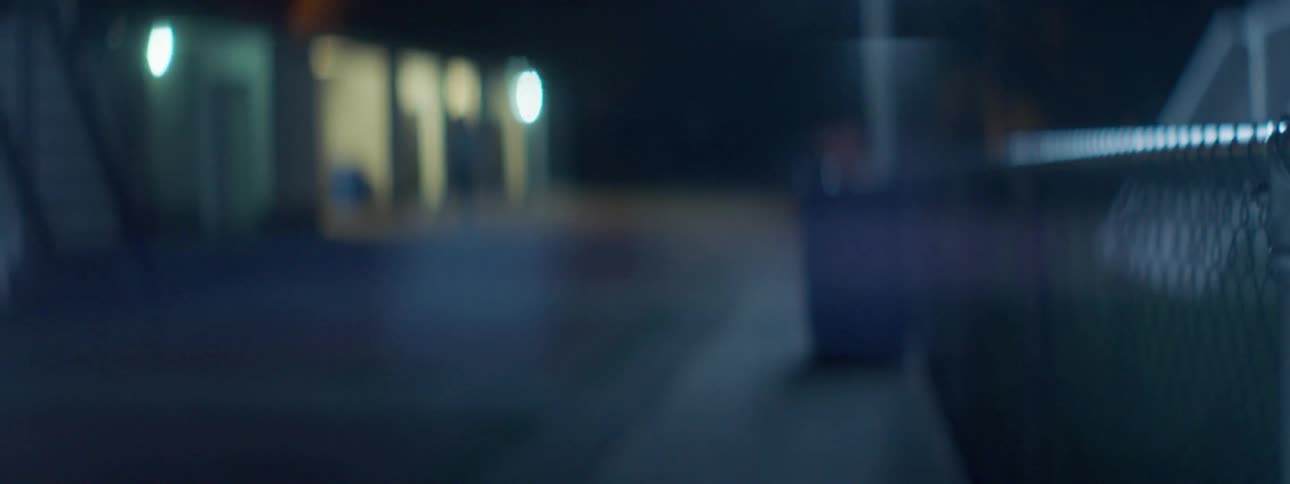 A blurry video of a parking lot at night