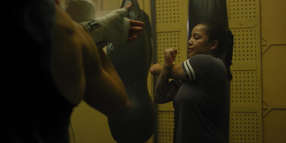 A woman is leading a group of fighters as they warm up