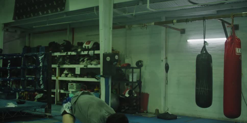 A man does exercises on the mat in the gym