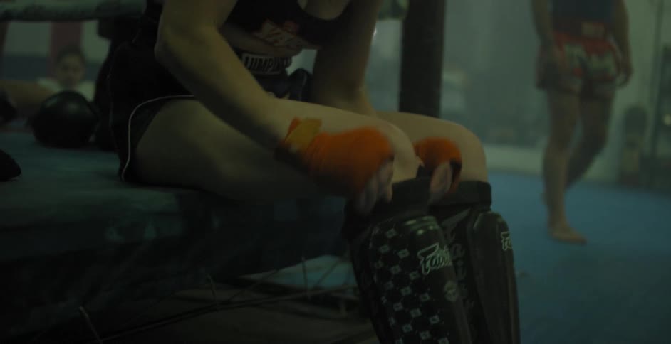 A woman  pulls on a shin guard