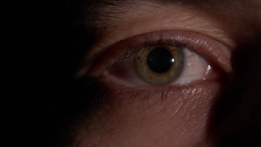 A person opens their eye