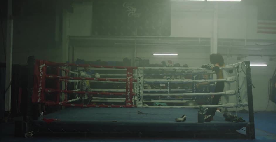Two people stand in a boxing ring