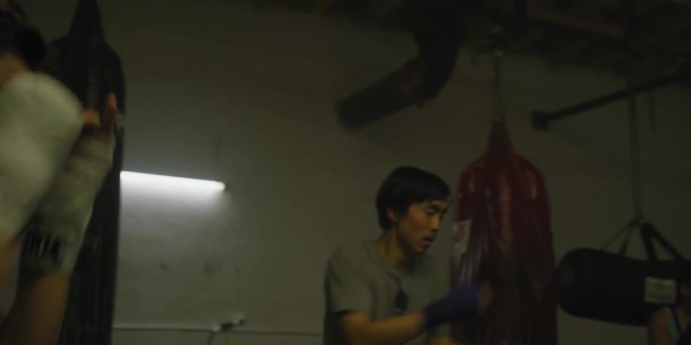Man and woman practice punches in a gym