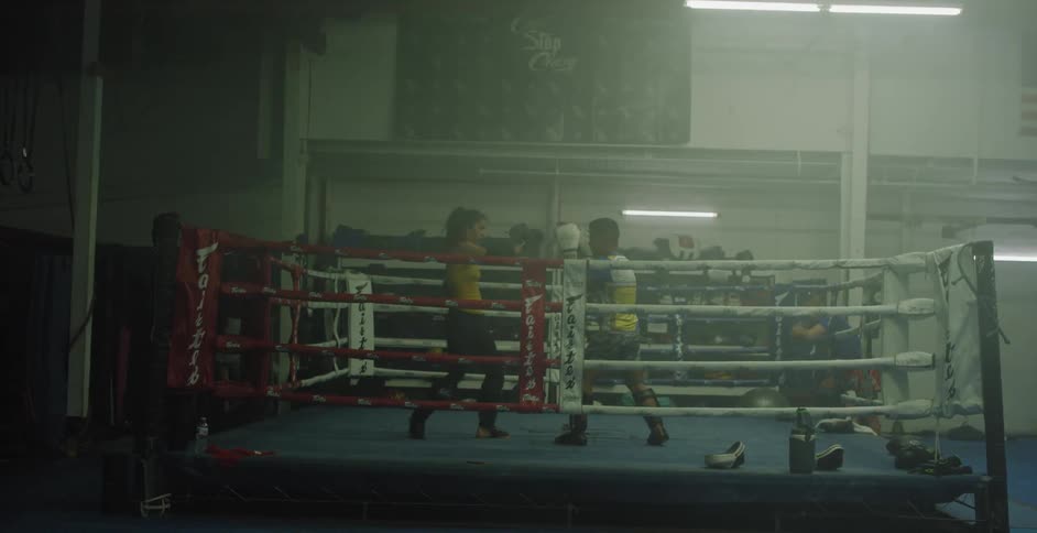 Man and woman practice boxing in a ring