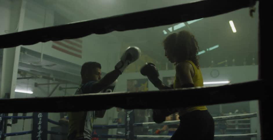 Man and woman spar in boxing ring