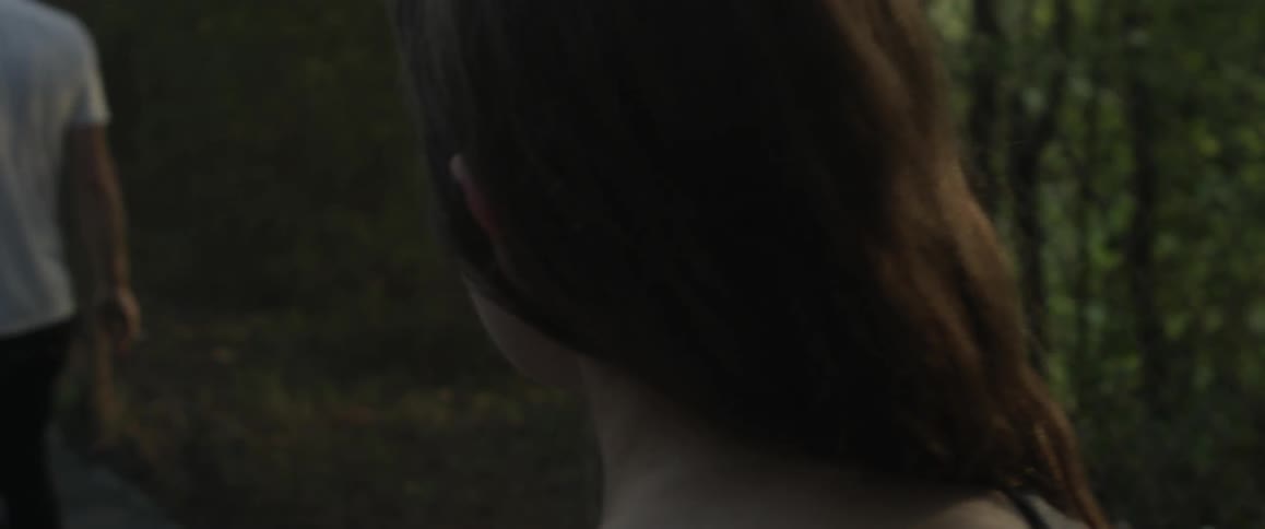 A man and woman are walking down the sidewalk