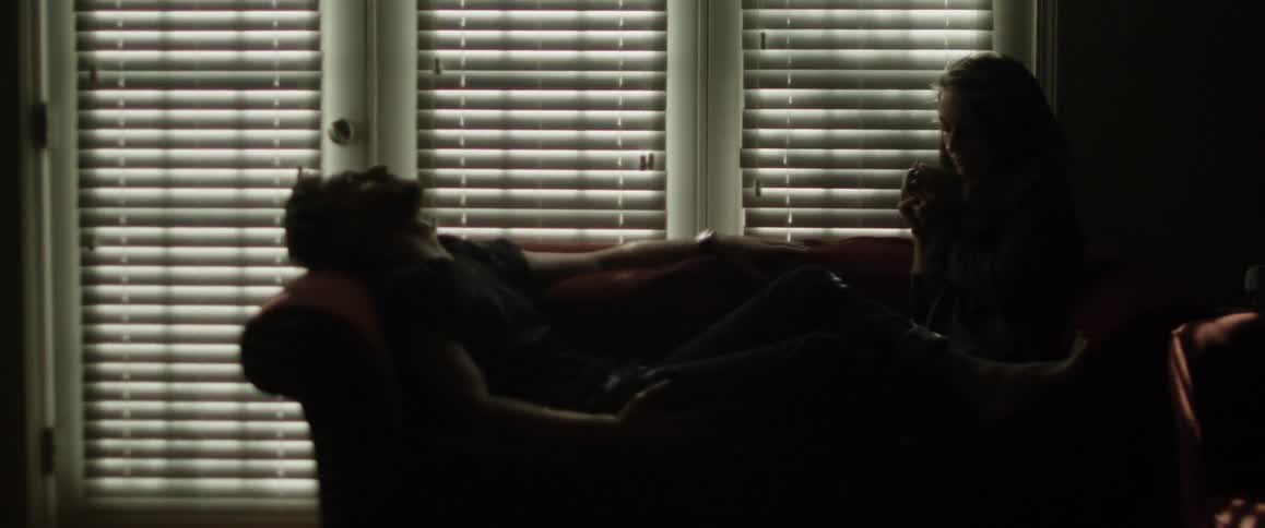 Man and woman relax on living room sofa