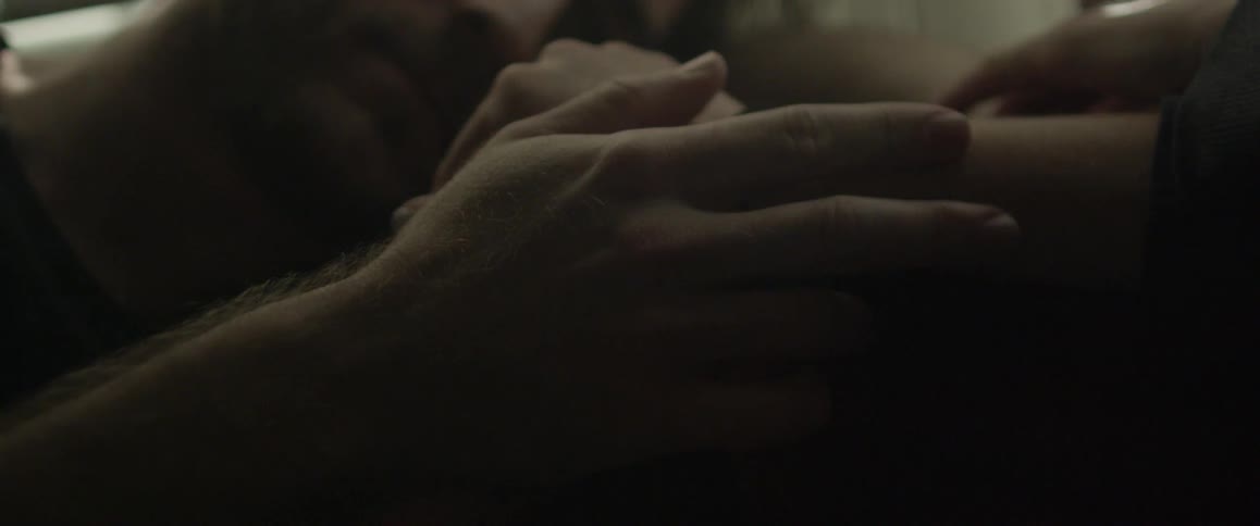 A person traces his hand along another's arm