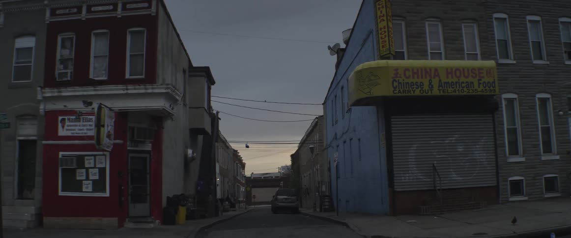 An alley between two buildings at dusk