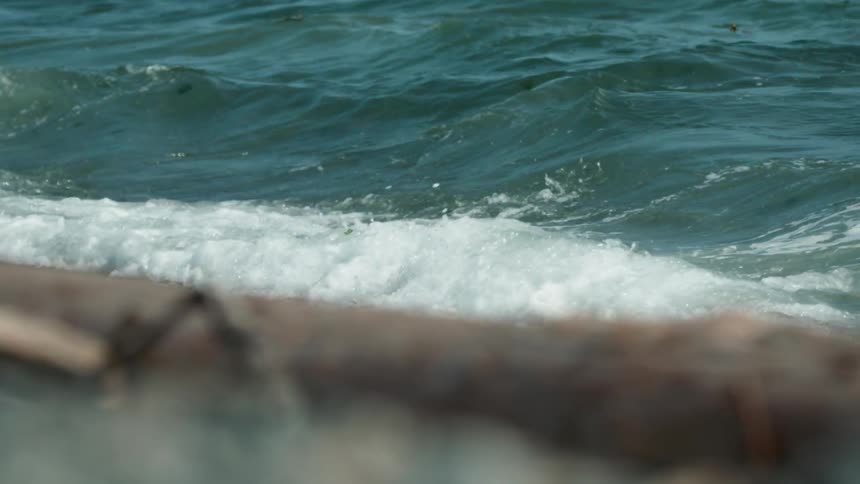 The waves slowly splash against the shore