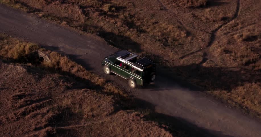 The vehicle travels down the small road