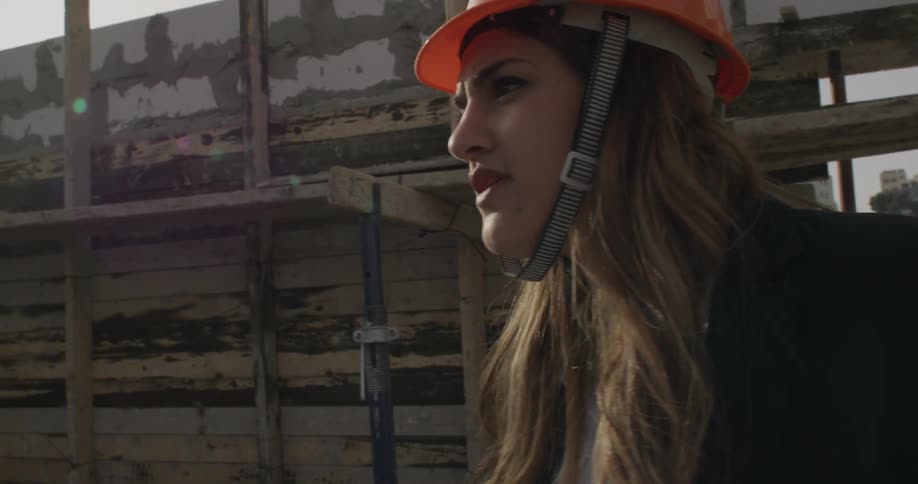 Woman holds plans in a construction site