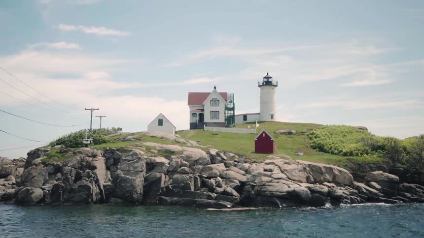 An island with a house and lighthouse on it