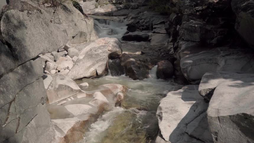 Water flows through rocks on a river