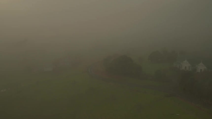 A building near a foggy road