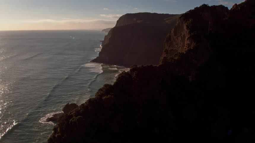 Ocean waves rolling up to cliffs