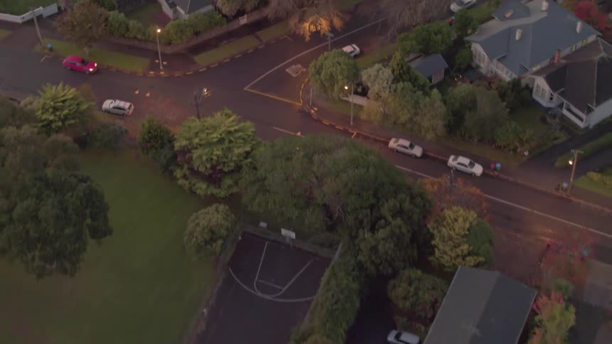 Cars commute through a neighborhood street