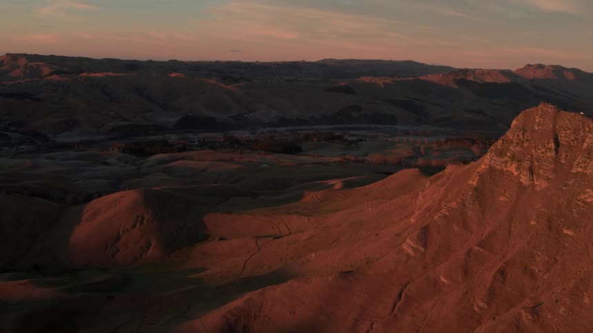 The setting sun is casting shadows on a desert landscape