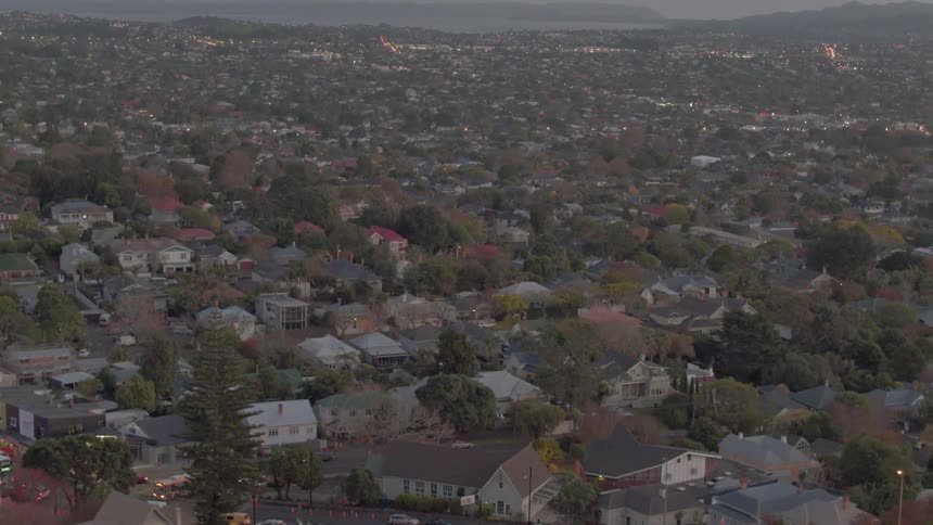 A community of homes and businesses stretches out between the ocean and hills
