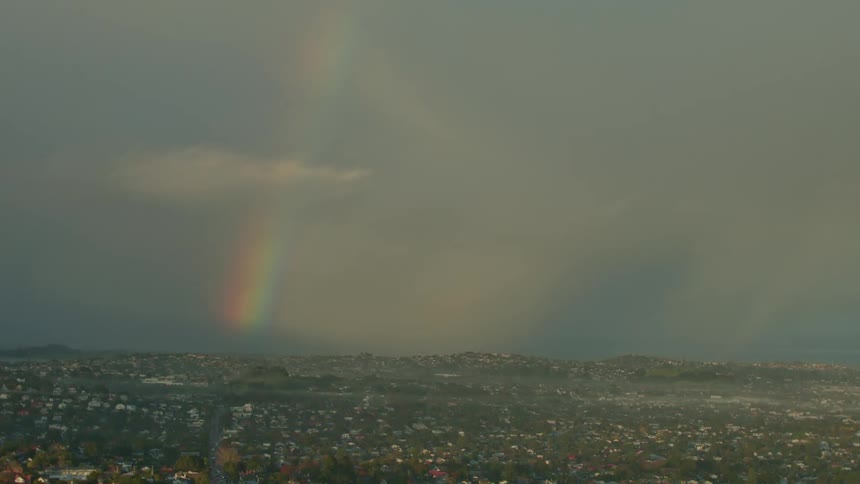 A rainbow shines above the landscape
