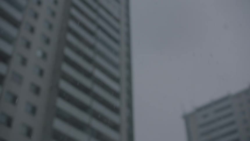 Snow is falling in a city