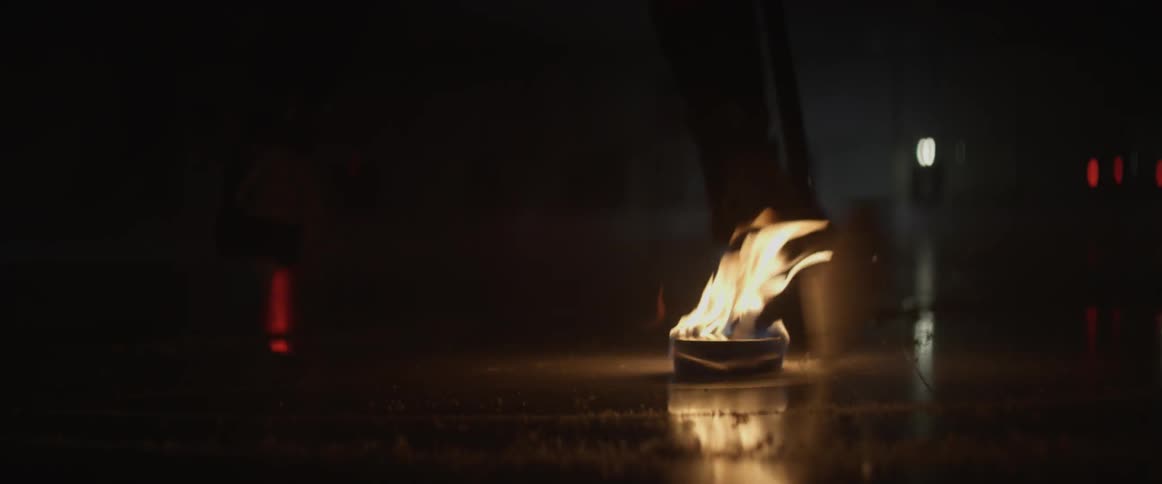 A hockey player is playing with a puck that is on fire