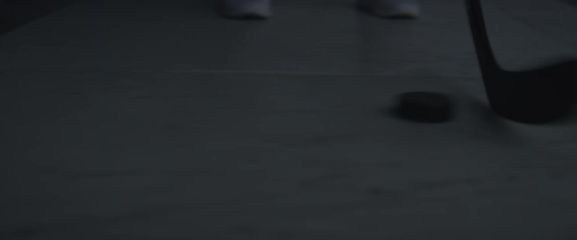 A man is practicing handling a puck with a stick