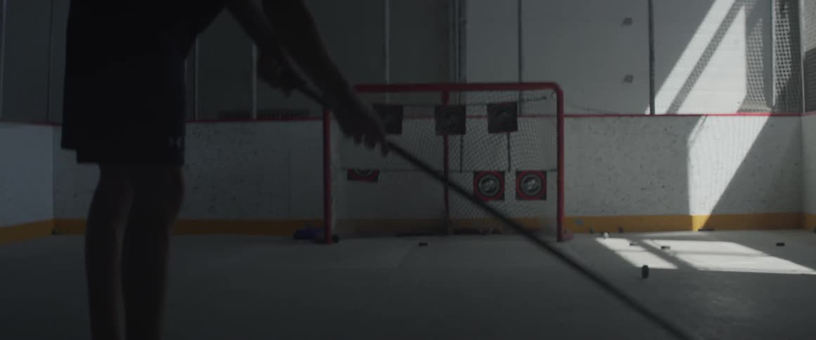 Man swings at hockey pucks