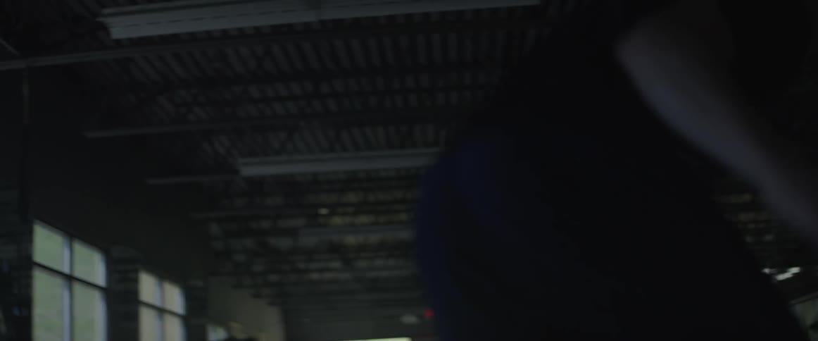 A man is running sprints inside a gym during the day