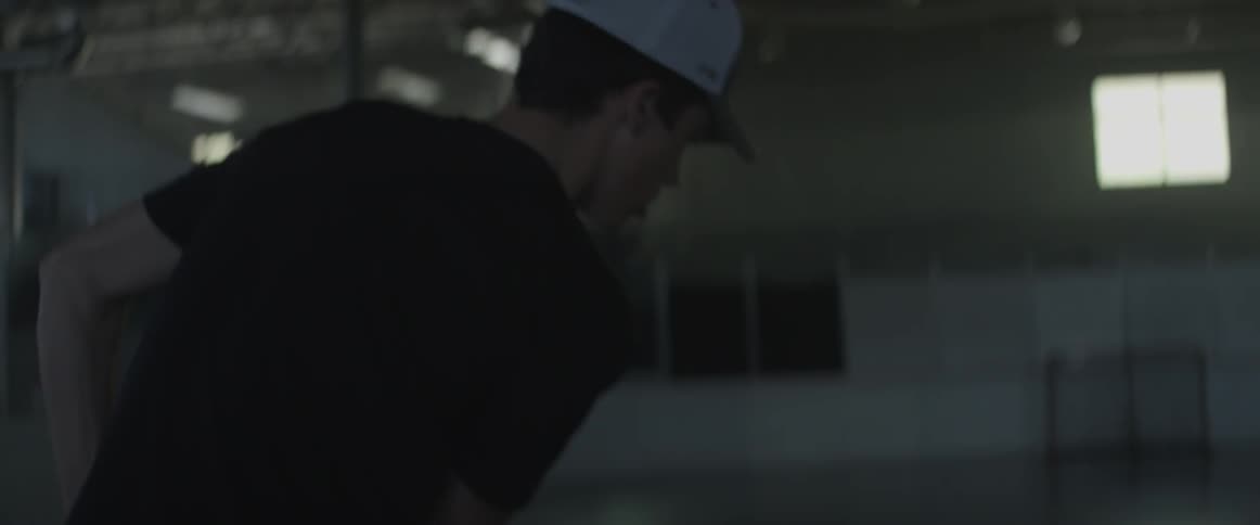 Young man practices stick work with an orange ball