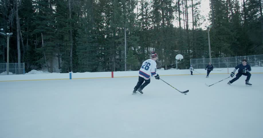 Men play hockey on an outdoor rink