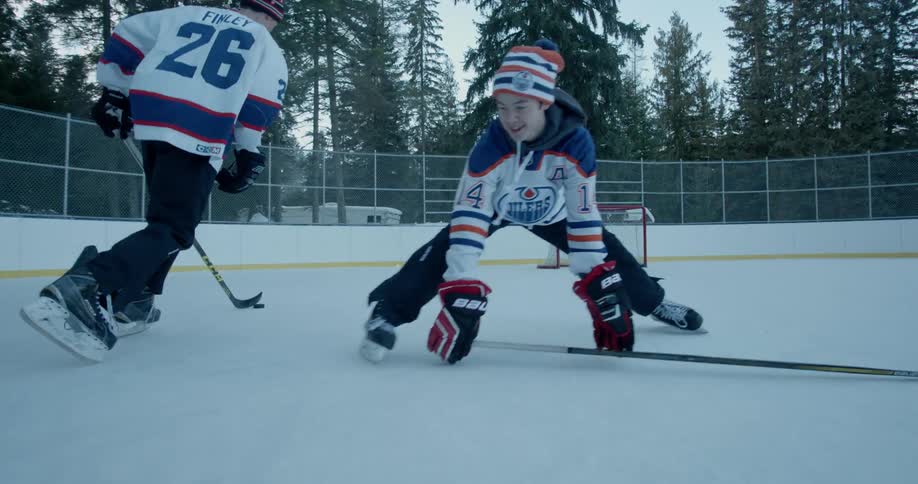 Hockey players play on an outdoor rink