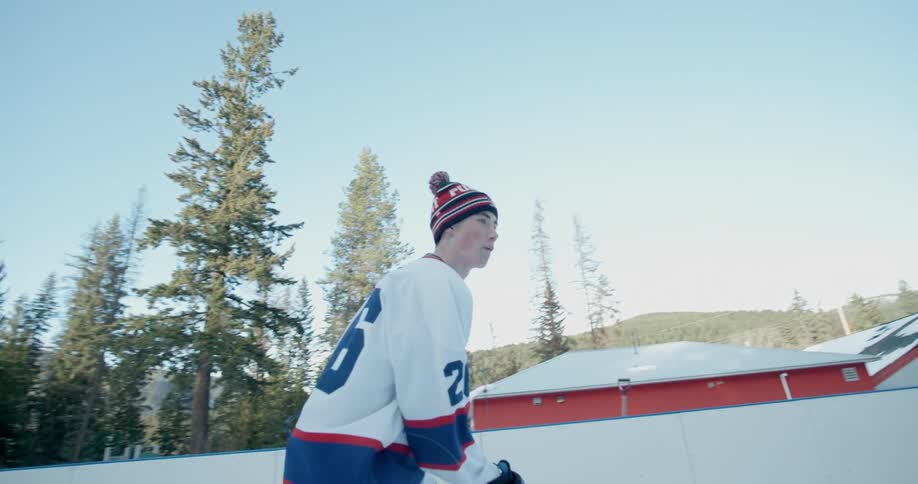 Hockey players play on an outdoor rink