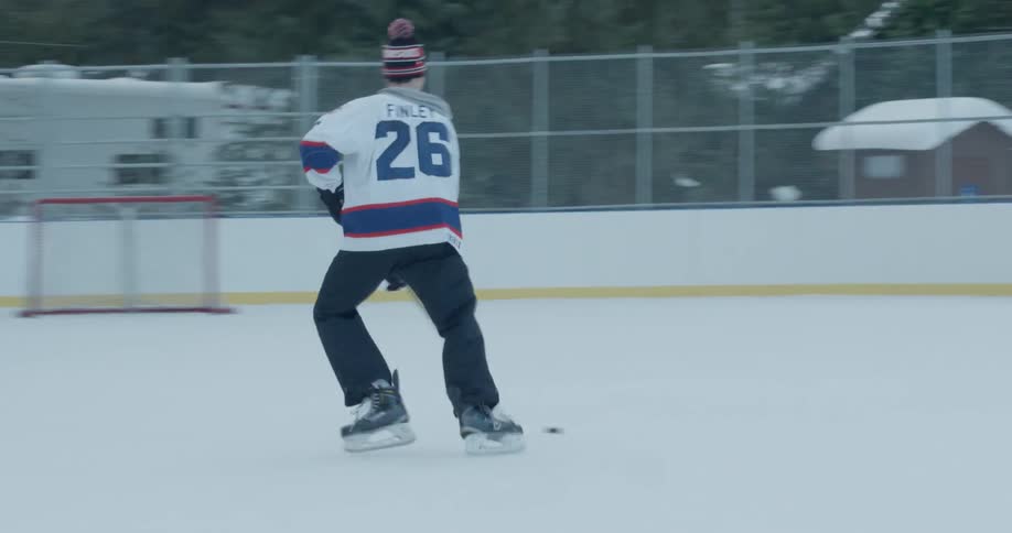 Hockey players play on an outdoor rink