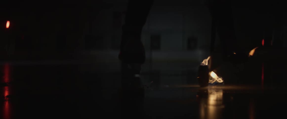 A hockey player hits a puck that is on fire