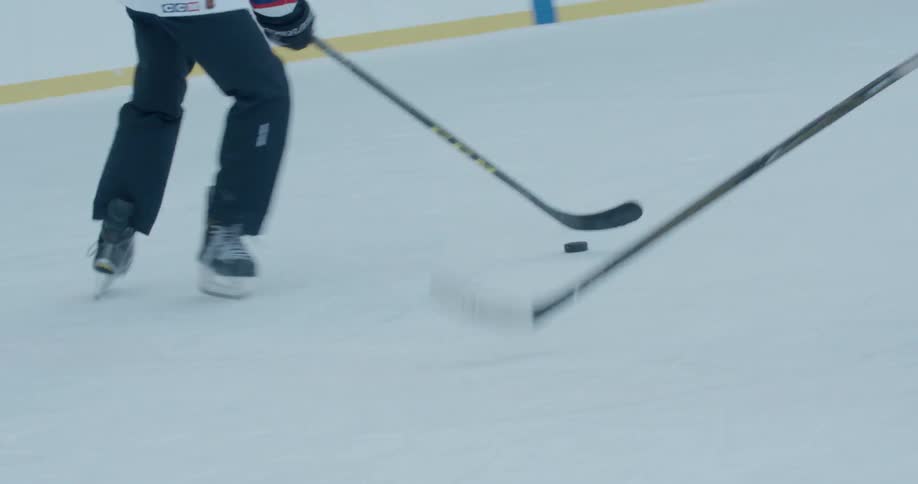 Two hockey players are playing hockey
