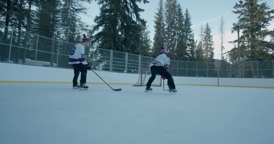 Men play hockey on an outdoor rink