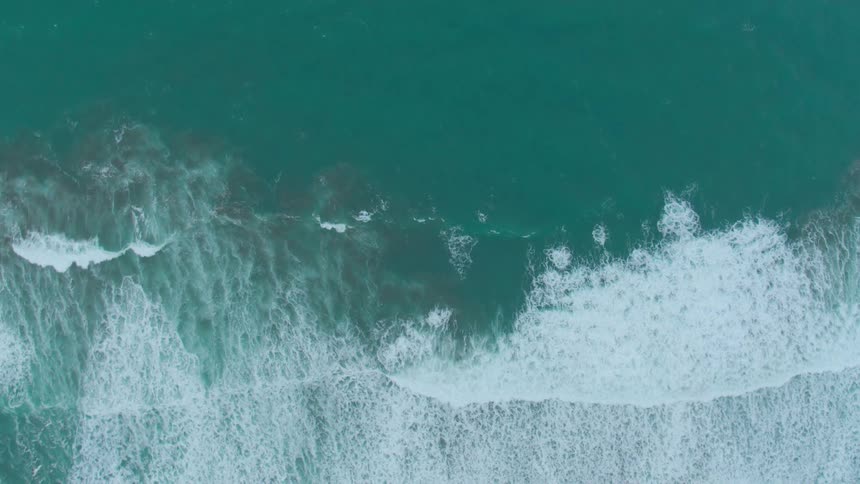 Waves flow onto the beach shore