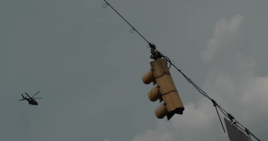 A helicopter hovers over a traffic signal