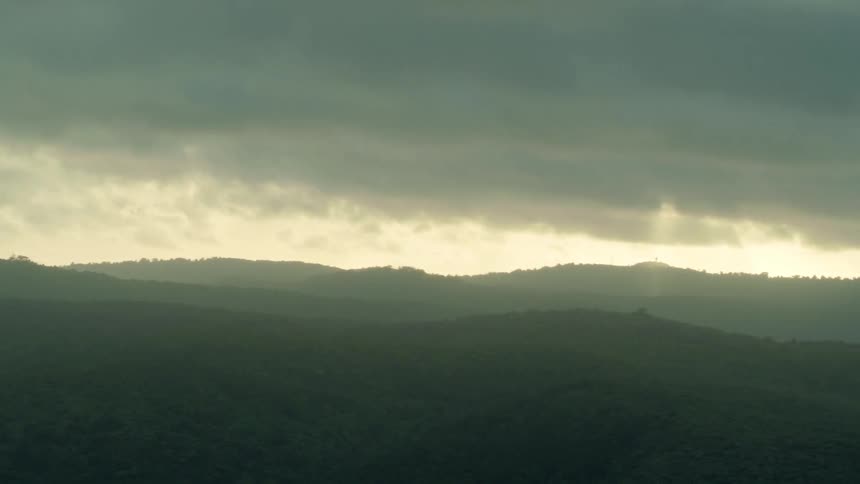 Gray clouds hang above the hills