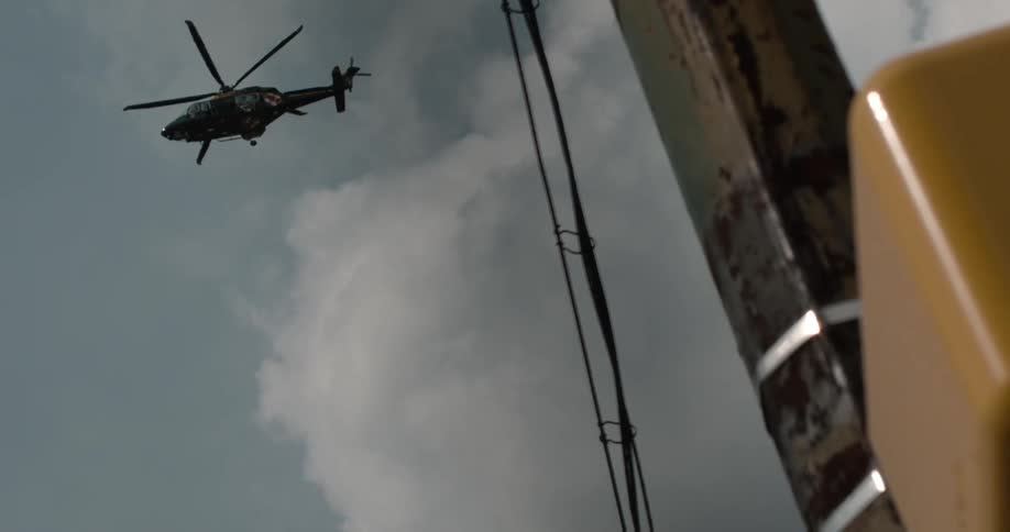 A helicopter flies over in slow motion