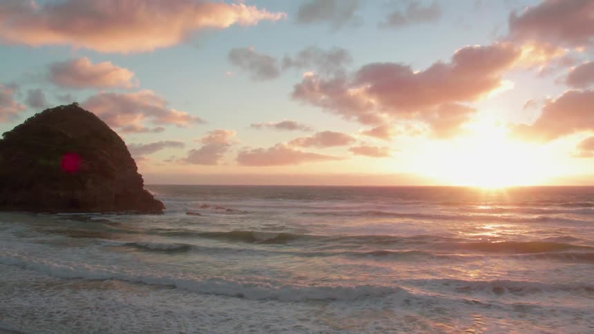 Ocean waves come to shore at sunset