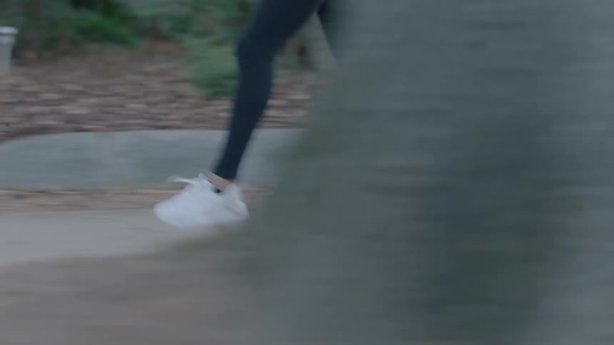 A woman jogs in place and then begins her run
