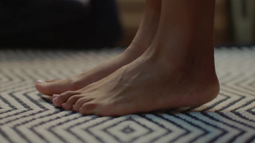 A person steps onto a diamond carpet