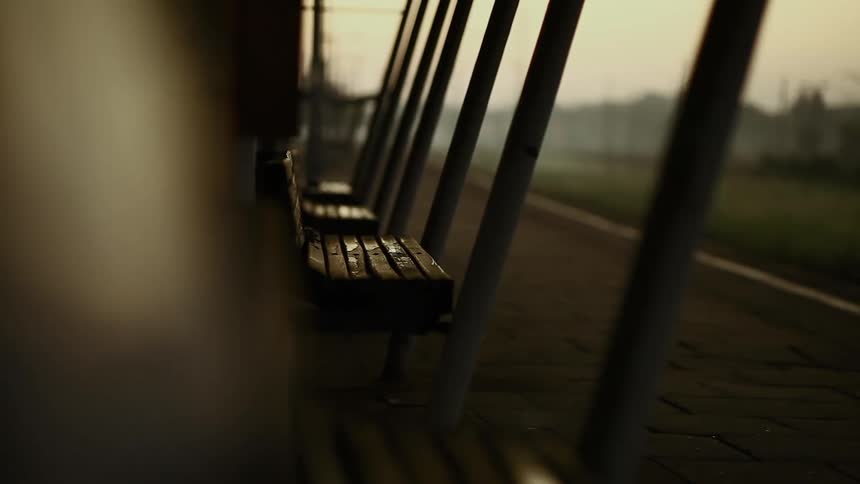 A static shot of damp, wooden benches