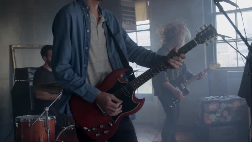 A rock band performs in a room