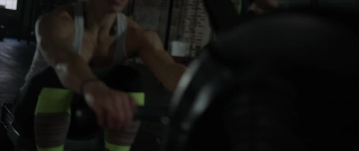 A man and woman exercise with row machines